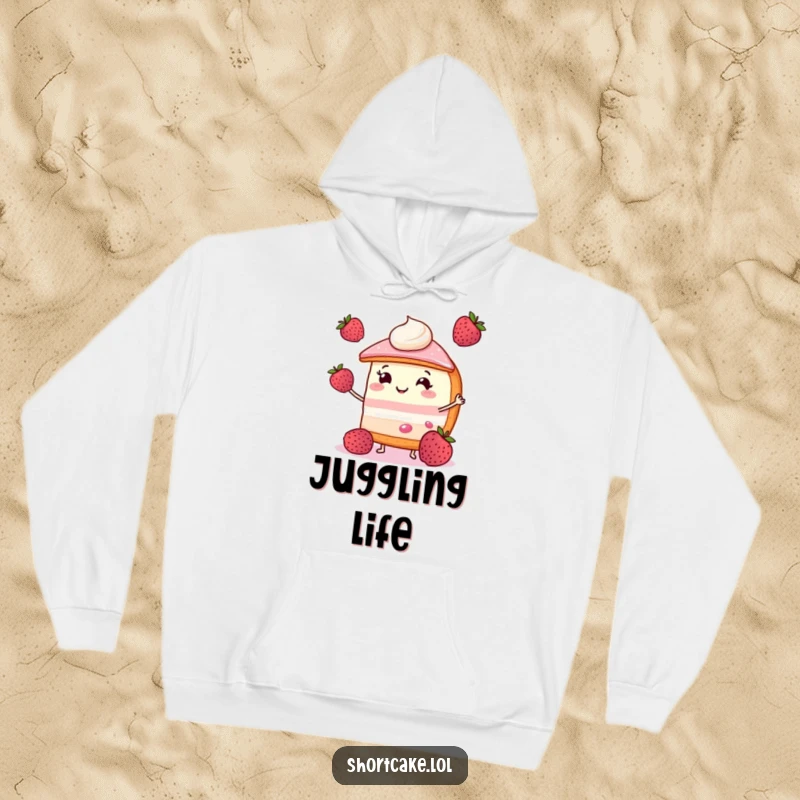 Funny shortcake hoodie with a smiling slice juggling three berries, ideal for cozy and joyful moments.