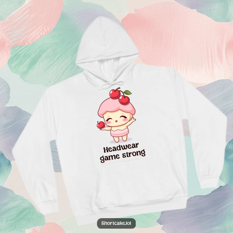 Funny shortcake character balancing a cherry on its point like a hat, a warm and humorous hoodie for cozy moments.