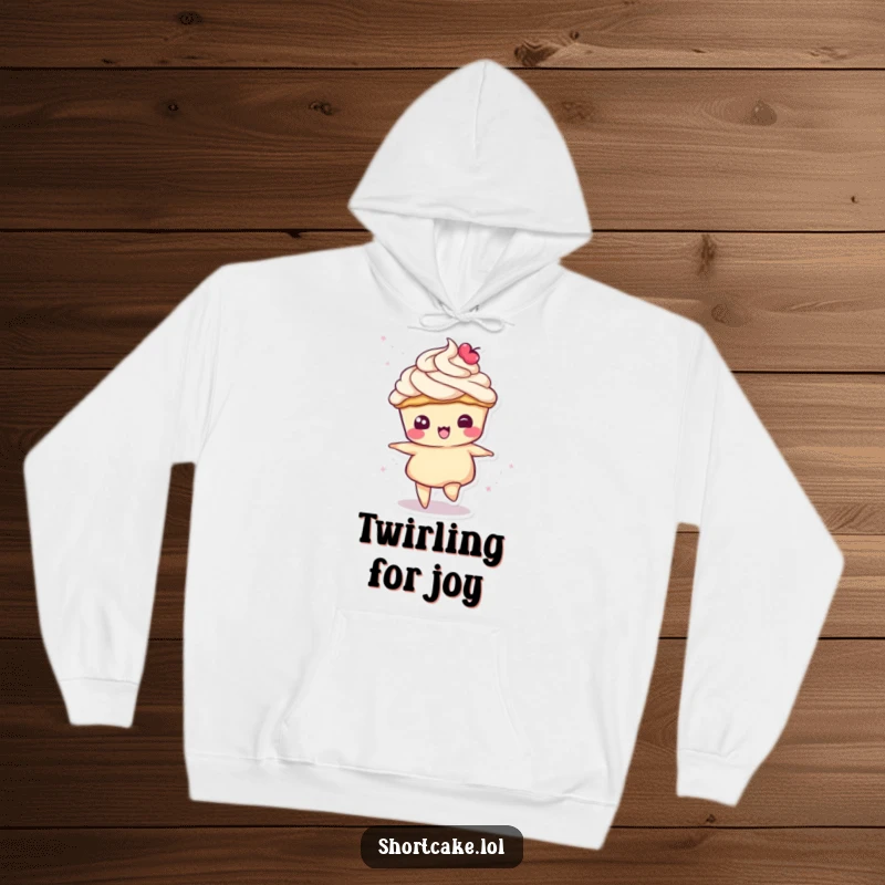 Funny hoodie featuring a shortcake slice character in a dynamic spin, its cream topping swirling charmingly.