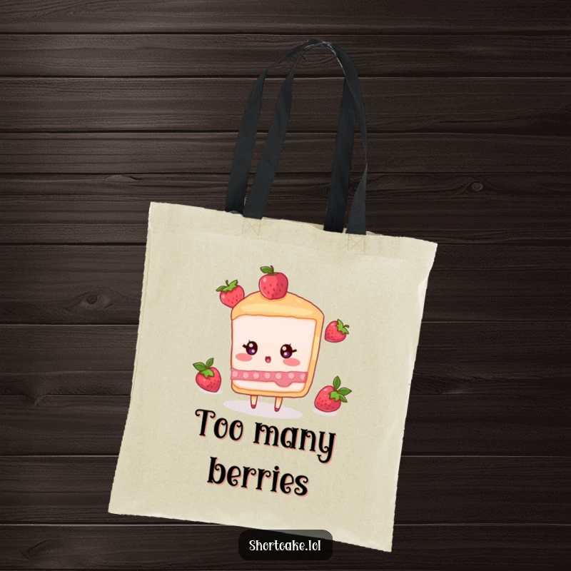 Funny tote bag with a shortcake slice character looking surprised as a berry tumbles down, great for carrying essentials.